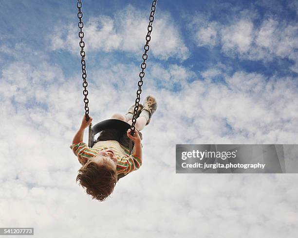 child in the swing - playground equipment stock pictures, royalty-free photos & images