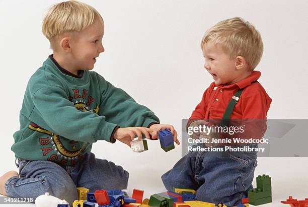 Boy And Toddler Playing With Lego, Bildbanksbilder