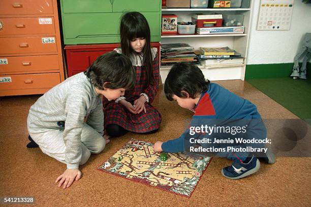 children playing snakes and ladders - snakes and ladders stock pictures, royalty-free photos & images