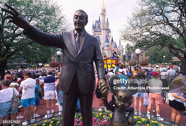 statue of walt disney and mickey mouse - disney world's magic kingdom stock pictures, royalty-free photos & images