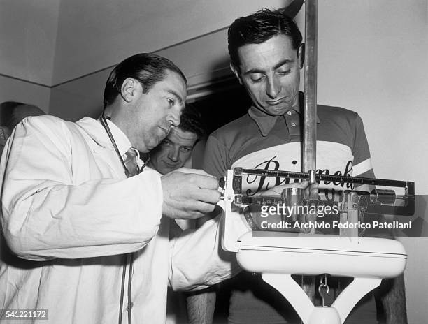 Doctor records the weight of champion cyclist, Fausto Coppi.