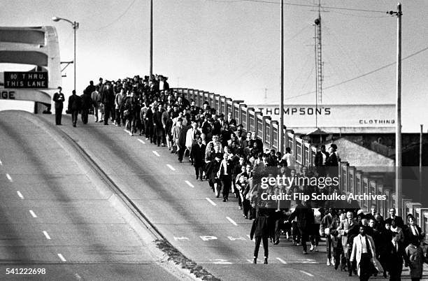 Civil rights activists march across the Edmund Pettus Bridge, starting the second march to Montgomery. In the first march, the marchers had been...