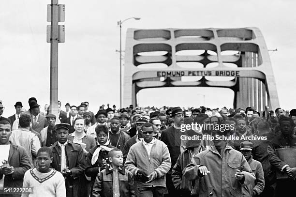 Civil rights activists march across the Edmund Pettus Bridge, starting the second march to Montgomery. In the first march, the marchers had been...