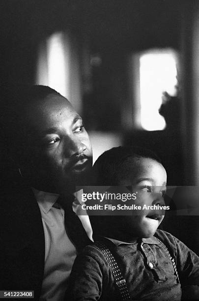 Martin Luther King Jr. Holds his young son Dexter on his lap at home in Atlanta.