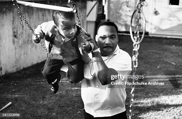 Martin Luther King Jr. Pushes his son Dexter on a swing in the backyard of their Atlanta home.