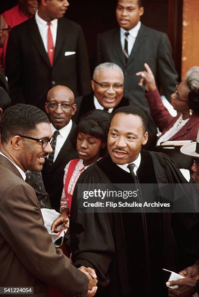 Reverend Martin Luther King Jr. Meets his parishioners at Ebenezer Baptist Church after Sunday services end. His father, the main pastor of the...