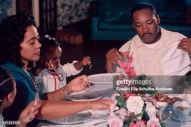 Martin Luther King Jr. Enjoys Sunday dinner with his wife Coretta and daughters Yolanda and Bernice.