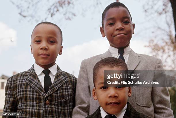 Martin Luther King Jr.'s sons Marty and Dexter stand with one of their cousins at home in Atlanta.