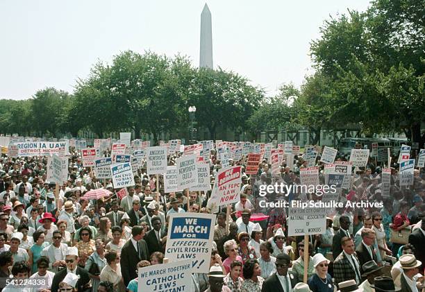 Dozens of civil rights marchers pass the Washington Monument during the March on Washington.