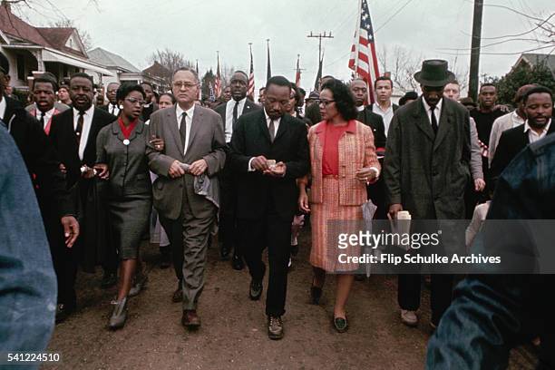 Martin Luther King Jr. And his wife Coretta march with other civil rights activists through a neighborhood in Selma.