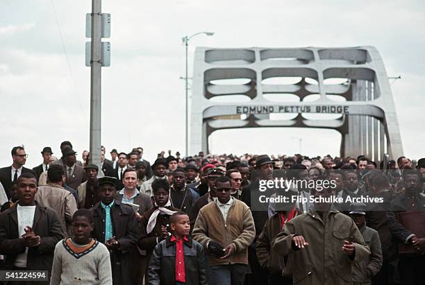 Civil rights marchers cross Edmund Pettus Bridge in the second attempt to march to Montgomery. The march was turned around by the police shortly...