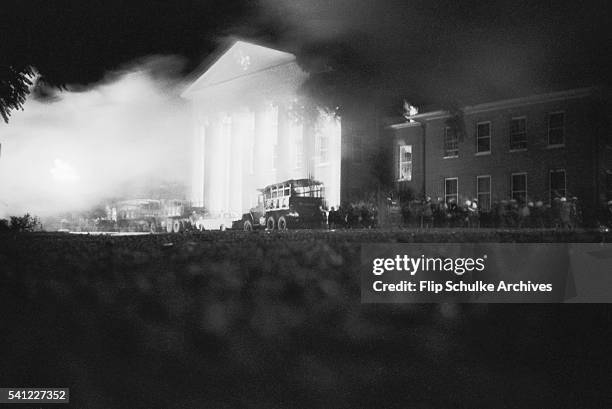 Marshals explode tear gas to subdue a nighttime riot by white students and their supporters on the University of Mississippi campus. The students...