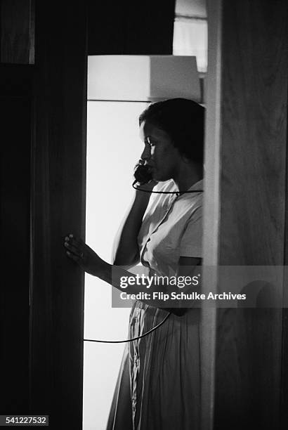 Myrlie Evers talks on a telephone in her house after the assassination of her husband, Civil Rights leader Medgar Evers.