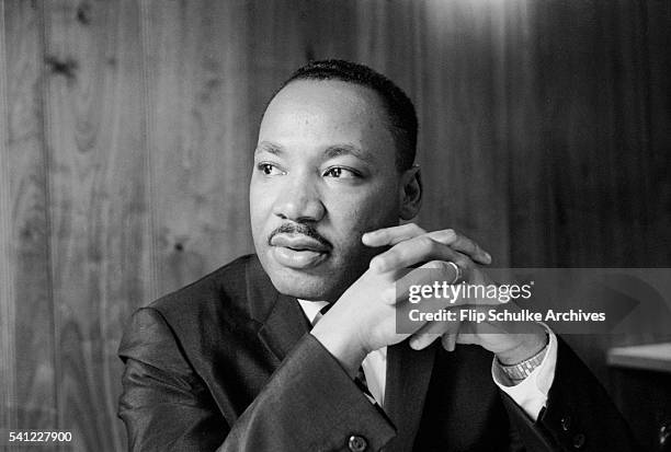 Civil rights leader Martin Luther King Jr listens at a meeting of the SCLC staff at an Atlanta restaurant.