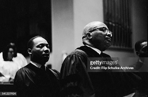 Martin Luther King Jr., behind his father Reverend Martin Luther King Sr., before delivering a sermon at Ebenezer Baptist Church.