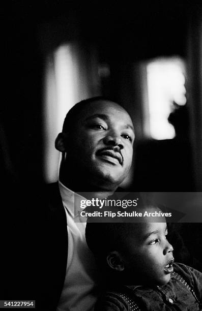 Martin Luther King Jr. Holds his son Dexter on his lap at home.