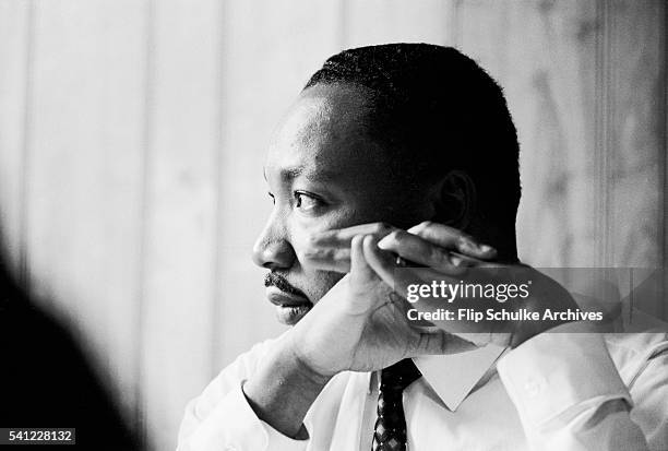 Civil rights leader Martin Luther King Jr. Listens at a meeting of the SCLC staff at an Atlanta restaurant.