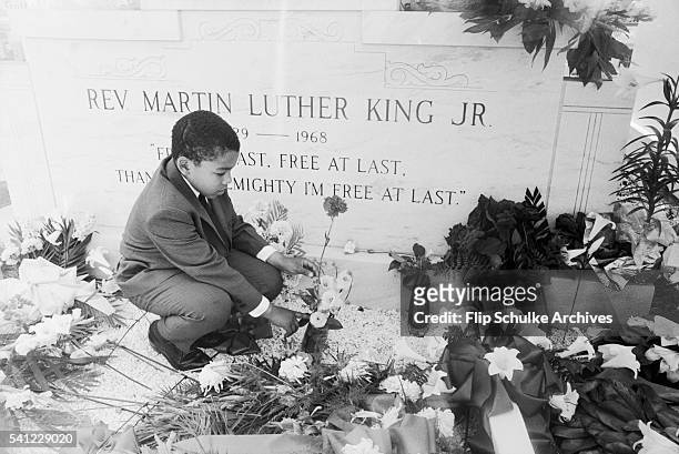 Dexter King visits the grave of his father Martin Luther King Jr. One year after his assassination.
