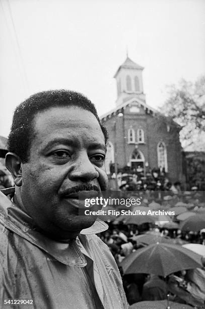 Civil rights activist Ralph Abernathy attends a rally in the rain at Dexter Avenue Baptist Church. The rally, held in the rain, commemorated Martin...