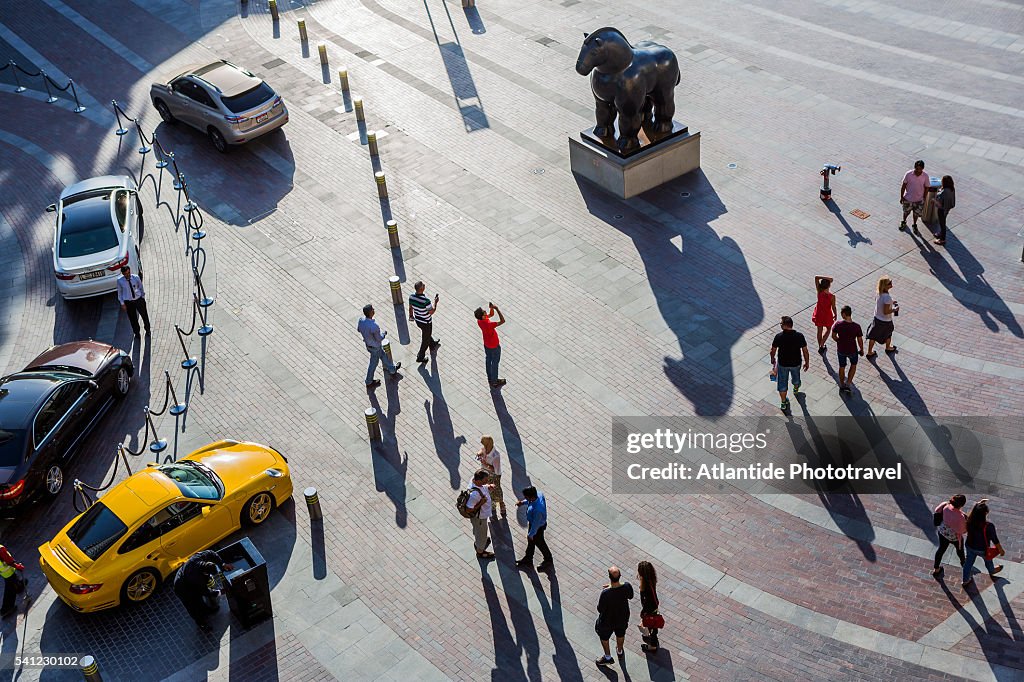 Downtown Dubai, people near the statue Horse 2007 by Fernando Botero