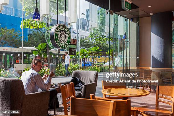 clarke quay, starbucks coffee near the central shopping mall - starbucks coffee stock pictures, royalty-free photos & images