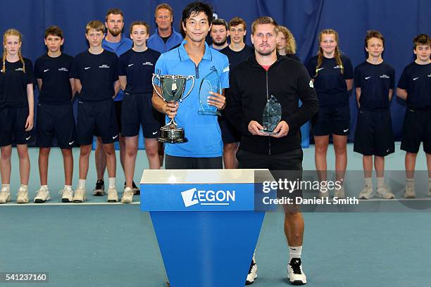 Yen-Hsun Lu of Taipei and Vincent Millot of France pose with their trophies after their men's singles final match during the final day of the Aegon...
