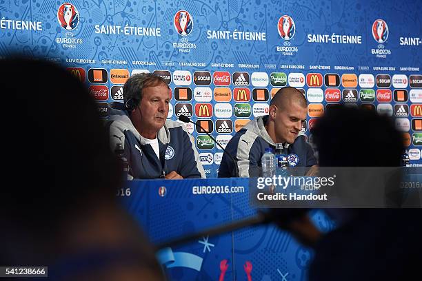 In this handout image provided by UEFA, Slovakia Head Coach Jan Kozak and Martin Skrtel of Slovakia face the media during the Slovakia Press...