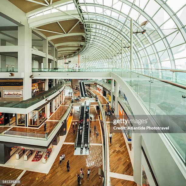 marina bay, the interior of the shopping mall the shoppes at marina bay sands - the shoppes stock pictures, royalty-free photos & images