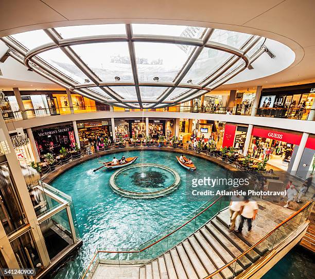 marina bay, boat for tourists on a canal inside the shopping mall the shoppes at marina bay sands - the shoppes stock pictures, royalty-free photos & images