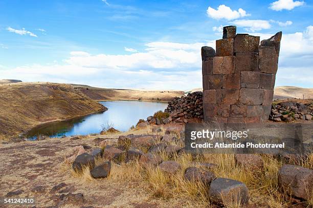 sillustani, pre-incan burial ground of the colla people on the shores of lake umayo. the tombs are built above ground in tower-like structures called chullpas - puno stock pictures, royalty-free photos & images