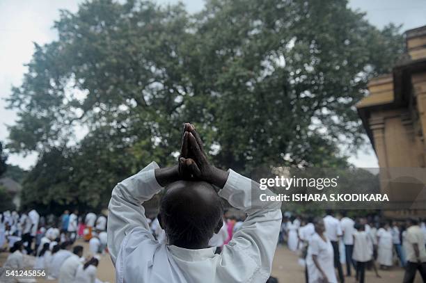 Sri Lankan Buddhists pray during Poya, a full moon religion festival, at the Kelaniya Temple in Kelaniya on June 19, 2016. Sri Lanka celebrates...