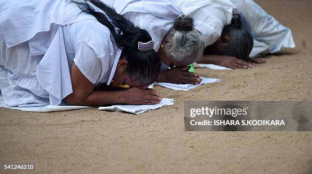 Sri Lankan Buddhists pray in Kelaniya temple on June 19, 2016 during Poya, a full moon religion festival. Sri Lanka celebrates "Poson", a Buddhist...