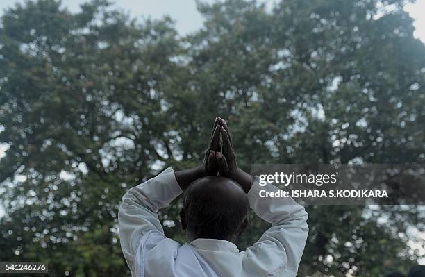 Sri Lankan Buddhist prays in Kelaniya temple on June 19, 2016 during Poya, a full moon religion festival. Sri Lanka celebrates "Poson", a Buddhist...