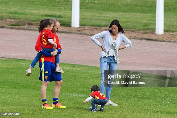 Andres Iniesta of Spain shares a moment with his wife Anna Ortiz, his daughter Valeria and his son Paolo Andrea after a training session at Complexe...
