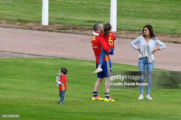 Andres Iniesta of Spain shares a moment with his wife Anna Ortiz, his daughter Valeria and his son Paolo Andrea after a training session at Complexe...