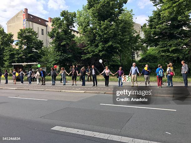 Participants form a human chain in a demonstration calling for tolerance of minorities and discouraging racism, on June 19, 2016 in Berlin, Germany.