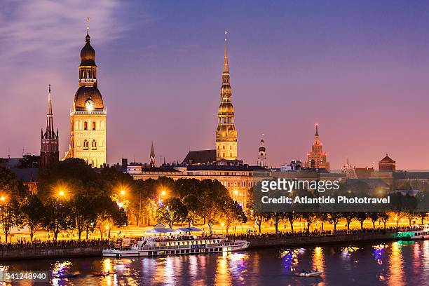 the daugava river with the bell-tower of st. savior anglican church, the bell-tower of the evangelical lutheran cathedral, the bell-tower of st. peter church and the latvian academy of science building - riga stock pictures, royalty-free photos & images