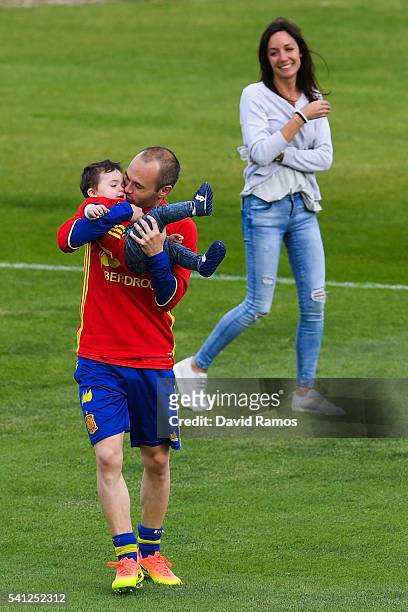 Andres Iniesta of Spain kisses his son Paolo Andrea as his wife Anna Ortiz reacts on the background after a training session at Complexe Sportif...