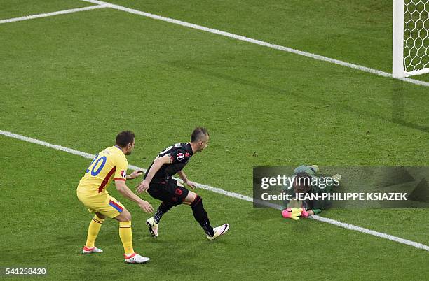Albania's goalkeeper Etrit Berisha makes a save in front of Albania's defender Ansi Agolli and Romania's midfielder Adrian Popa during the Euro 2016...