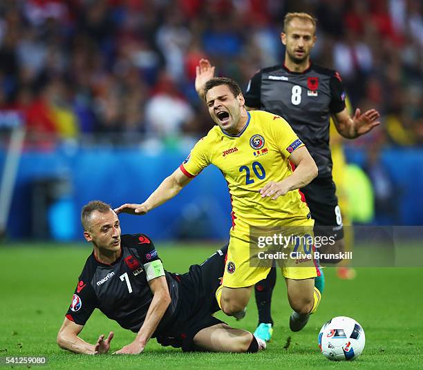 Adrian Popa of Romania is tackled by Ansi Agolli of Albania during the UEFA EURO 2016 Group A match between Romania and Albania at Stade des Lumieres...