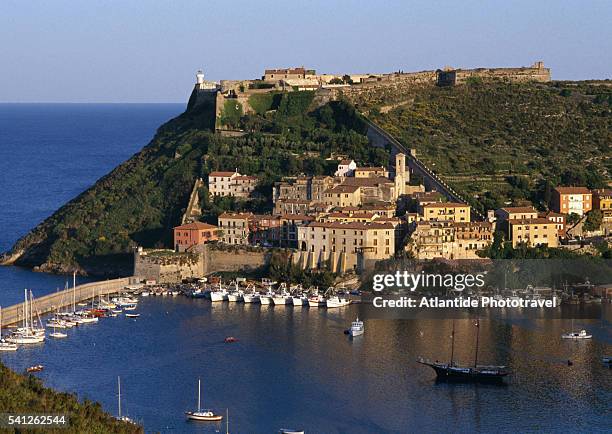 coastal village and fortress above - オルベテッロ ストックフォトと画像