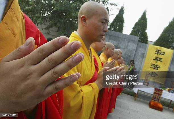 Monks pray during a religious ceremony to commemorate the Nanjing Massacre and pray for peace at the Nanjing Massacre Victims Memorial on September...