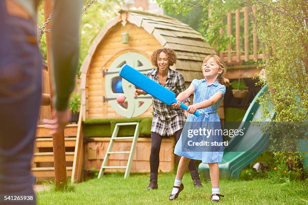 playing cricket in the garden - family cricket stockfoto's en -beelden