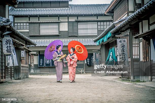two beautiful japanese women in kimono coming, kyoto - red parasol stock pictures, royalty-free photos & images