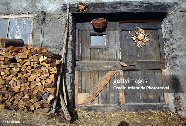 doorway and firewood pile - alpes de haute provence stock pictures, royalty-free photos & images