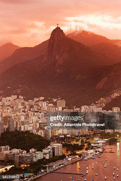 view of the town with the cristo redentor from the pao de acucar (sugarloaf mountain) at the sunset - rio de janeiro cristo stock pictures, royalty-free photos & images