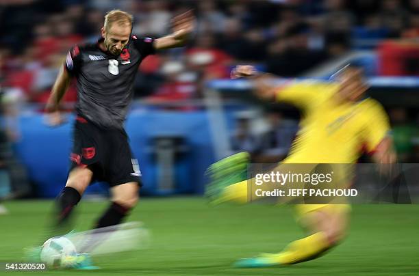 Albania's midfielder Migjen Basha vies for the ball during the Euro 2016 group A football match between Romania and Albania at the Parc Olympique...