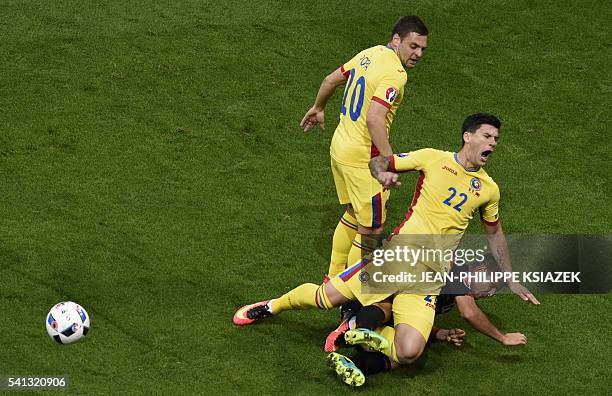 Romania's defender Cristian Sapunaru is challenged by Albania's defender Andi Lila during the Euro 2016 group A football match between Romania and...