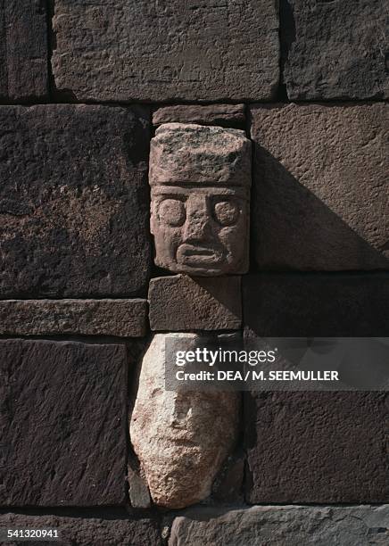 Stone heads embedded in wall of Tiwanaku's Semi-subterranean Temple , Bolivia. Pre-Inca Tiahuanaco civilisation, 2nd-4th century.