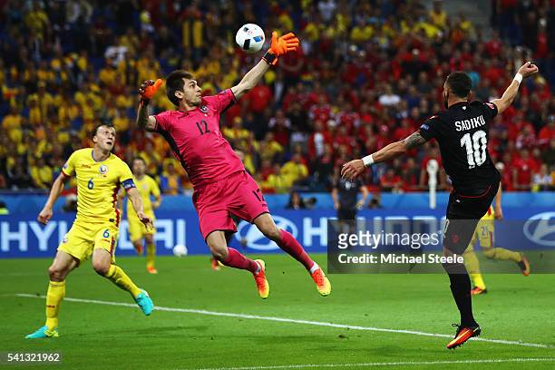 Armando Sadiku of Albania heads the ball to score the opening goal past Ciprian Tatarusanu of Romania during the UEFA EURO 2016 Group A match between...